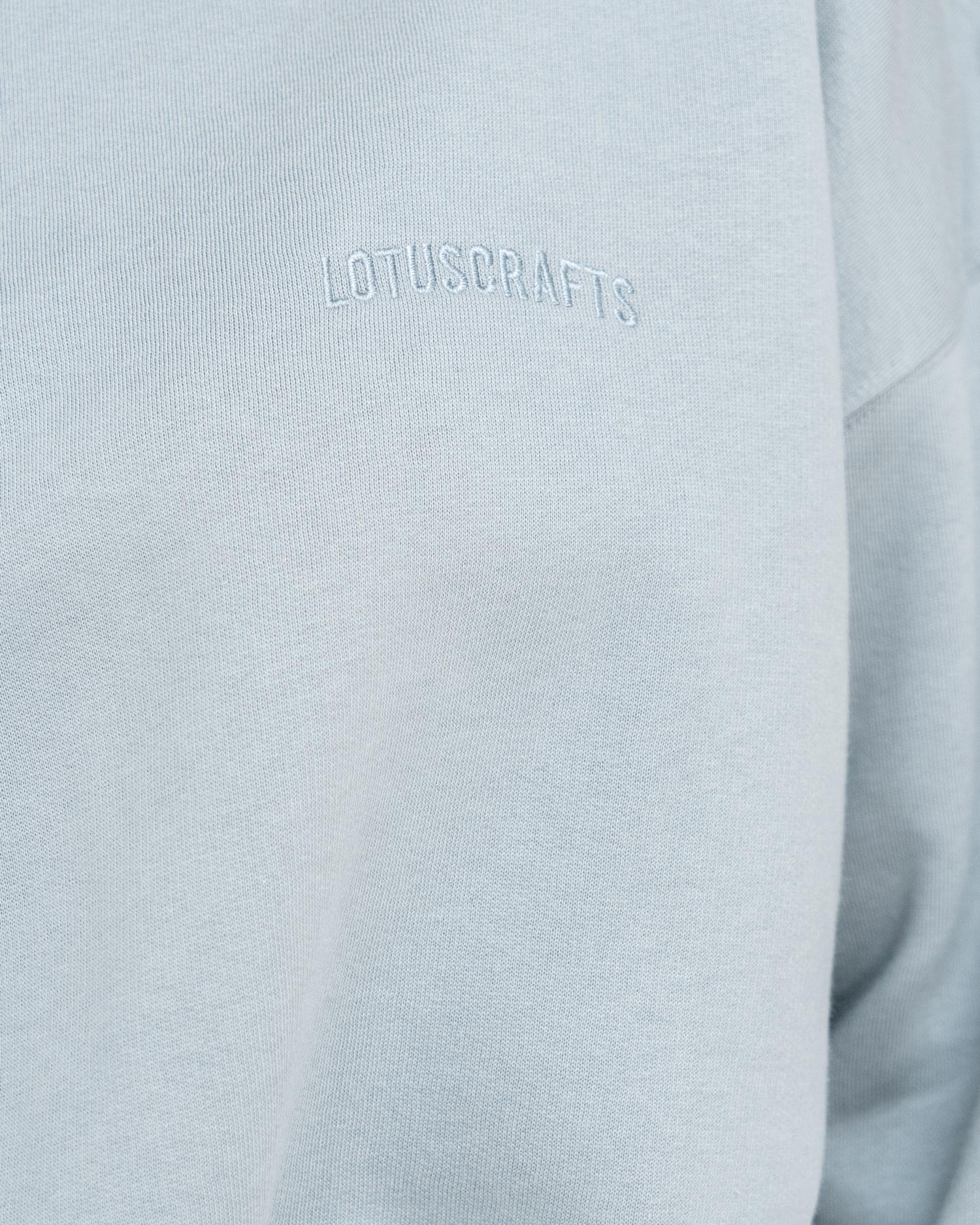 Stone Blue - Model in cropped Yoga Sweater Detail Logo Lotuscrafts
